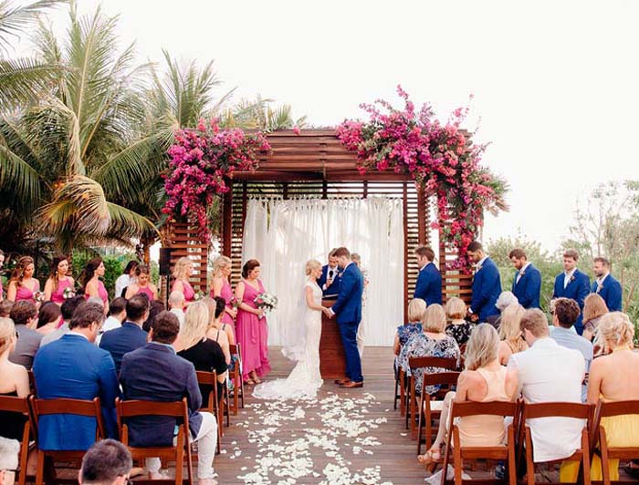 Destination wedding couple consulting with an elite travel specialist on the beach